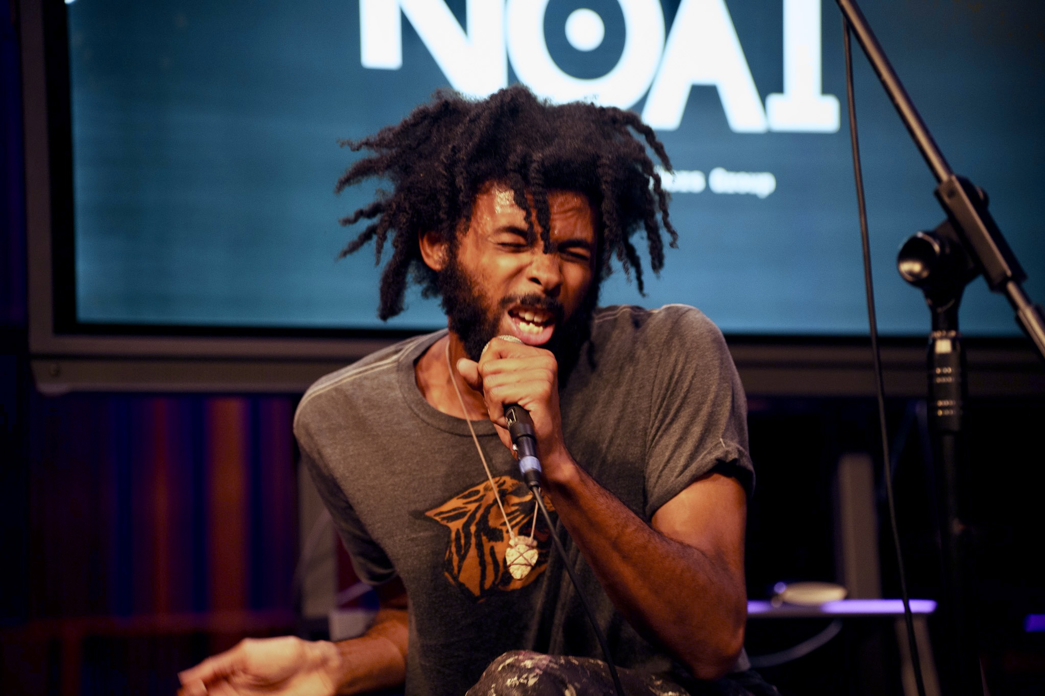 A singer singing with great emotion into a microphone.